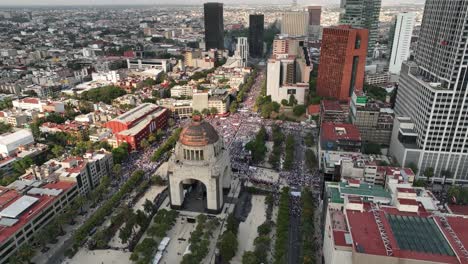 Cinematic-drone-shot-over-a-crowd-gathered-at-the-monument-of-revolution-in-the-city-of-Mixquic-in-Mexico