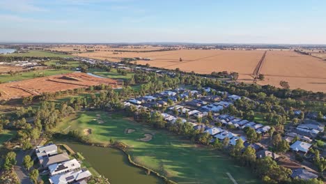Over-golf-course-and-residential-area-with-wheat-fields-and-new-building-zone-beyond-near-Yarrawonga
