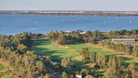 Aerial-across-golf-course-to-new-homes-and-Lake-Mulwala-and-dead-trees-in-the-water-beyond