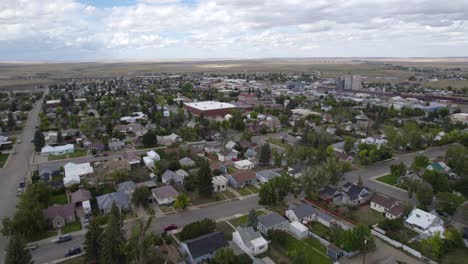 Cut-Bank-city-main-street-and-residential-area-rooftops-from-above,-Montana