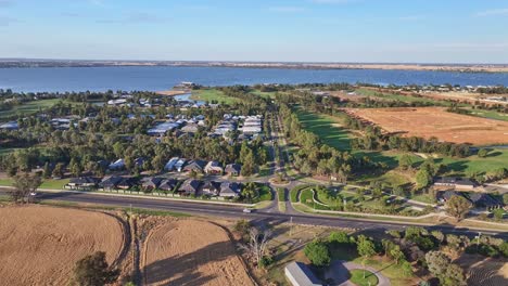 Yarrawonga,-Victoria,-Australia---22-November-2023:-Over-wheat-fields-and-approaching-Silverwoods-Estate-with-the-golf-course-and-Lake-Mulwala-beyond