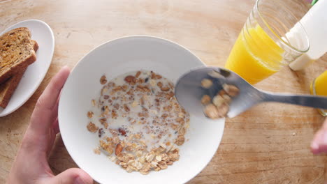 Point-of-view-of-man-eating-cereal-and-drinking-juice