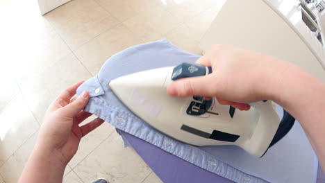 Point-of-view-of-man-ironing-shirt