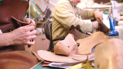 Bespoke-Shoemaker-Measuring-And-Cutting-Leather-For-Shoe