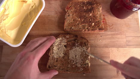 Point-Of-View-Shot-Showing-Person-Spreading-Butter-On-Toast