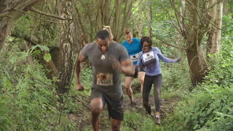 Competitors-running-through-a-forest-at-an-endurance-event