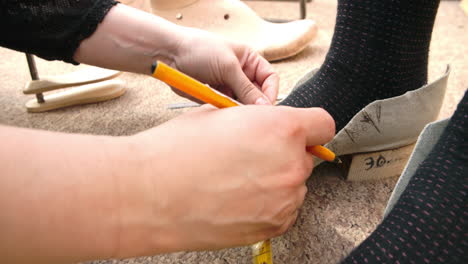 Bespoke-Shoemaker-Measuring-Customer's-Foot-For-Shoe