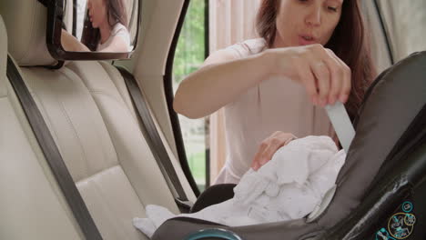 Mother-Putting-Baby-Son-Into-Car-Travel-Seat