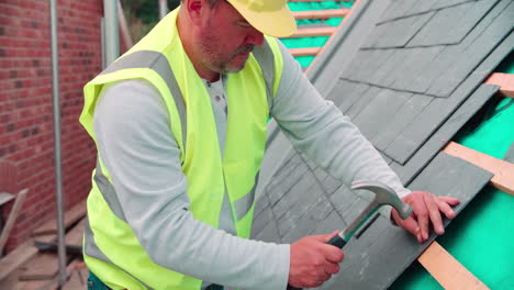 Construction-Worker-On-Building-Site-Laying-Slate-Tiles