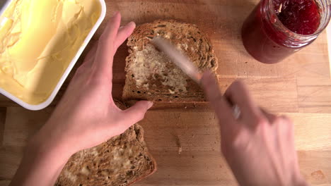 Point-Of-View-Shot-Showing-Person-Spreading-Jam-On-Toast