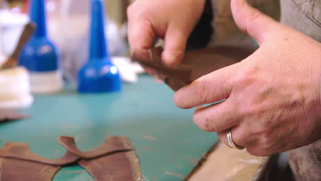 Bespoke-Shoemaker-Glueing-Together-Leather-Pieces-For-Shoe