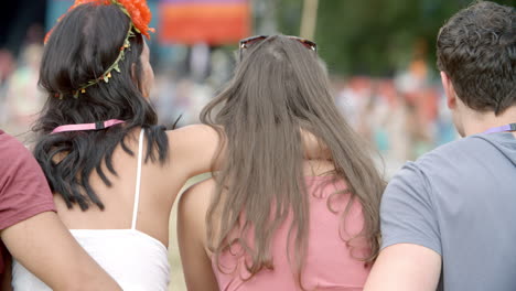 Back-view-of-friends-sitting-talking-at-a-music-festival