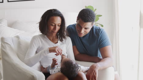 Happy-young-African-American-parents-spending-time-with-their-baby-son,-close-up