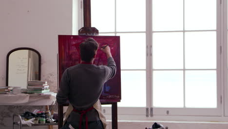 Male-Artist-Works-On-Painting-In-Daylight-Studio-Shot-On-R3D