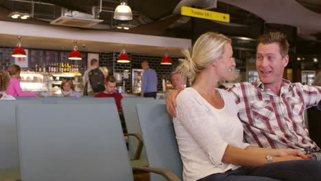 Couple-Waiting-In-Airport-Departure-Lounge-Shot-On-R3D