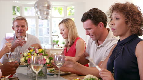 Mature-Friends-Around-Table-At-Dinner-Party-Shot-On-R3D