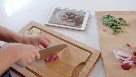 Man-Follows-Recipe-On-Digital-Tablet-In-Kitchen-Shot-On-R3D