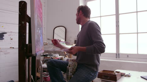 Male-Artist-Working-On-Painting-In-Studio-Shot-On-R3D