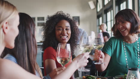 Group-Of-Female-Friends-Making-A-Toast-At-Meal-In-Restaurant