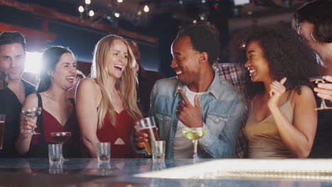 Group-Of-Couples-With-Friends-Drinking-In-Bar-Together