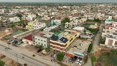Aerial-View-Of-Solar-Panels-On-Rooftop-Of-Building-In-Badin-City-In-Sindh,-Pakistan
