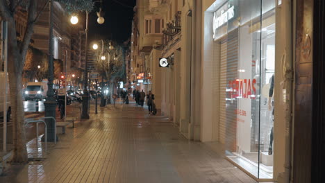 People-walking-on-Carrer-de-Colon-in-night-Valencia-Spain
