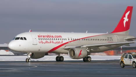 Airplane-A320-of-Air-Arabia-taxiing-at-Sheremetyevo-Airport-winter-view-Moscow