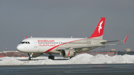 Airbus-A320-of-Air-Arabia-taxiing-in-Moscow-airport-winter-view