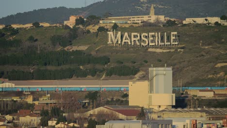 Marseille-view-with-city-name-on-green-hills-France