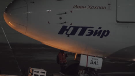 Pushback-of-Utair-airplane-at-night-View-with-cockpit-and-pilot-in-the-cabin