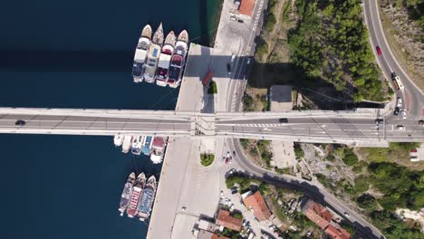 Aerial-top-down-of-Dr-Franjo-Tudman-Bridge-as-cars-drive-below,-Dubrovnik-Croatia