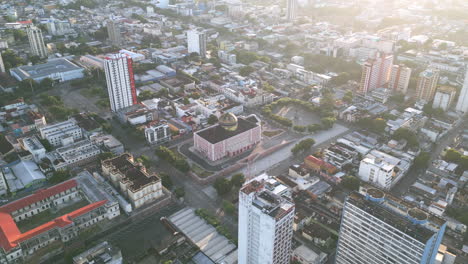 Aerial-wide-footage-of-the-Teatro-Amazonas,-Amazon-Theatre-in-Manaus,-Brazil-in-the-light-of-the-sunrise