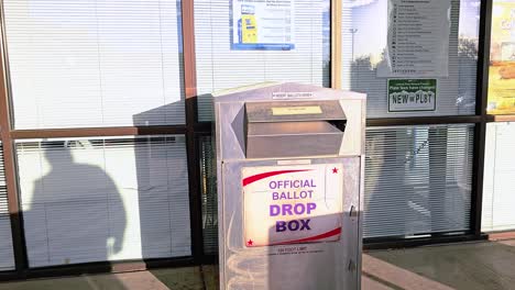 Man-Votes-by-Dropping-Mail-in-Ballot-Letter-in-Slot-at-Voting-Booth-with-Offical-Ballot-Drop-Box-Sign-for-Democratic-Government-Election-in-Presidential-Race