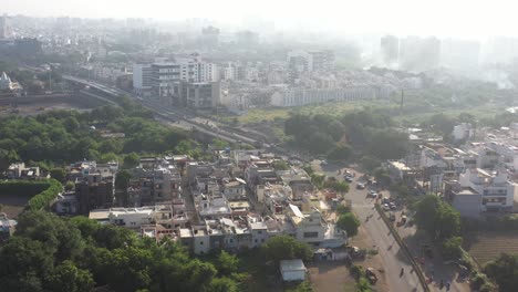 Rajkot-city-aerial-view-from-top-angle-Drone-is-moving-forward-and-many-vehicles-are-going-on-the-road-and-construction-work-is-going-on-near-main-road-at-city
