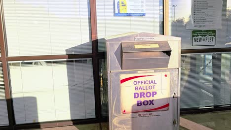 Gen-Z-Young-Man-Votes-by-Dropping-Mail-in-Ballot-Letter-in-Slot-at-Voting-Booth-with-Offical-Ballot-Drop-Box-Sign-for-Democratic-Government-Election-in-Presidential-Race