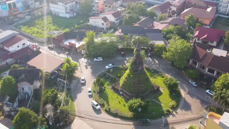 Aerial-Overhead-View-Of-That-Dam-On-Roundabout-In-Vientiane,-Laos-On-Sunny-Day-With-Lens-Flares