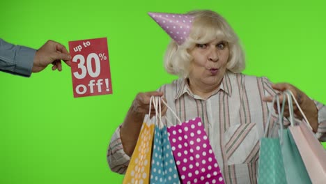 Inscription-Up-To-30-Percent-Off-appears-next-to-grandmother.-Woman-celebrating-with-shopping-bags