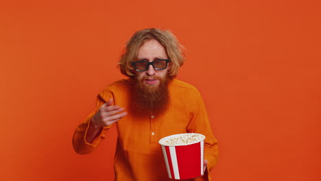 Excited-man-in-3D-glasses-eating-popcorn-watching-interesting-tv-serial-sport-game-cinema-film