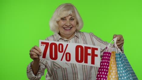 Grandmother-with-shopping-bags-showing-Up-To-70-percent-Off-banner.-Online-shopping-with-low-prices