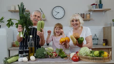 Grandchild-girl-with-senior-grandparents-recommending-eating-raw-vegetable-food.-Nutrition-diet