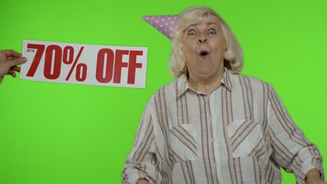 Advertisement-Up-To-70-Percent-Off-appears-next-to-grandmother.-Woman-celebrating-with-shopping-bags