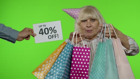Inscription-Up-To-40-Percent-Off-appears-next-to-grandmother.-Woman-celebrating-with-shopping-bags