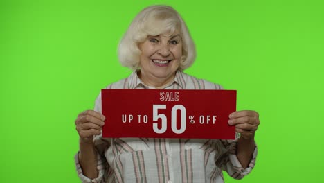 Senior-grandmother-showing-Up-To-50-percent-Off-inscription,-advertising-discounts,-looking-amazed