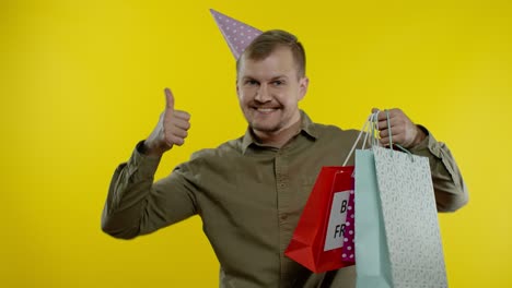 Man-raising-shopping-bags,-dancing,-celebrating,-enjoying-discounts-on-Black-Friday-sale-holiday