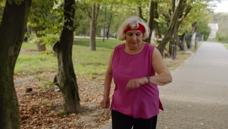 Elderly-sport-runner-woman-training.-Workout-cardio-in-park.-Active-senior-people.-Fitness