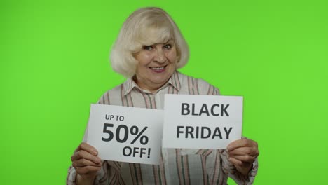 Grandmother-showing-Black-Friday-and-Up-To-50-Percent-Off-shopping-price-discount-advertisement