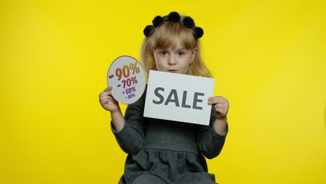 Child-girl-showing-Sale-word-and-discounts-advertisement-inscriptions-banners.-Black-Friday-concept