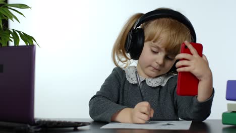 Preschool-child-girl-distance-online-learning-at-home.-Kid-studying-using-digital-mobile-phone