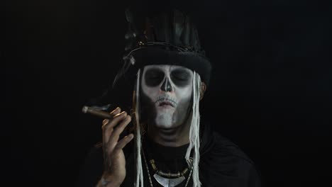 Creepy-man-with-skeleton-makeup-in-top-hat.-Guy-smoking-cigar,-opening-his-eyes,-making-faces