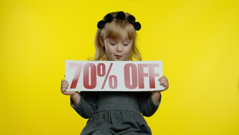 Child-girl-showing-Up-To-70-percent-Off-inscription,-rejoicing-discounts-for-online-shopping-sales